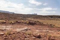 this is an image of a deserted landscape on a clear day with rocky ground and mountains