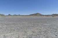 a red truck is driving through the rocky landscape of the desert of an arid area