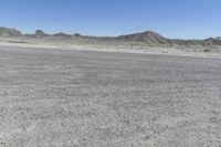 a red truck is driving through the rocky landscape of the desert of an arid area