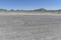 a red truck is driving through the rocky landscape of the desert of an arid area