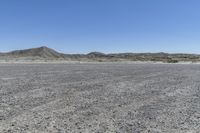 a red truck is driving through the rocky landscape of the desert of an arid area