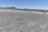 a red truck is driving through the rocky landscape of the desert of an arid area