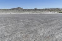 a red truck is driving through the rocky landscape of the desert of an arid area