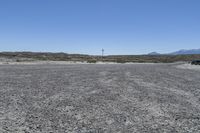 a red truck is driving through the rocky landscape of the desert of an arid area