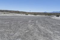 a red truck is driving through the rocky landscape of the desert of an arid area