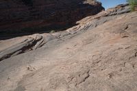 two birds that are sitting on some rocks by itself in the desert on a sunny day