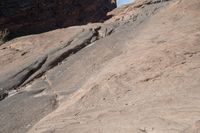 two birds that are sitting on some rocks by itself in the desert on a sunny day