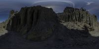 an image of some very large mountains near some clouds and cloudscapes and some hills and some rocks and grass