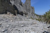 a rocky cliff face is seen from a high angle with no one visible on it