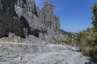 a rocky cliff face is seen from a high angle with no one visible on it