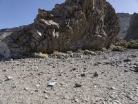 a rocky outcropping in the middle of nowhere with a clear sky above