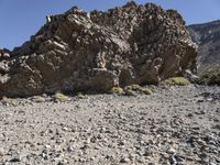 a rocky outcropping in the middle of nowhere with a clear sky above