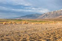 an open desert plain with a big mountain in the background and some dirt on the ground