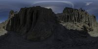 an image of some very large mountains near some clouds and cloudscapes and some hills and some rocks and grass