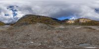 a big mountains area that has some rocks on it and people riding bikes near by