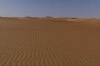 the photo shows a desert with no one on it or someone riding a horse or a car