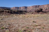 the mountains rise from the ground and brown, brown, and green terrain in front of them