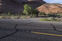 a motorcycle sits on the side of the road in the desert, looking towards a mountain