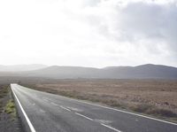 the road is empty and the sky is mostly cloudy in the background, as if in the picture it is clear