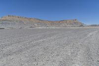 a red truck is driving through the rocky landscape of the desert of an arid area