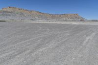 a red truck is driving through the rocky landscape of the desert of an arid area