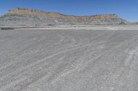 a red truck is driving through the rocky landscape of the desert of an arid area