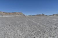 a red truck is driving through the rocky landscape of the desert of an arid area