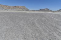 a red truck is driving through the rocky landscape of the desert of an arid area
