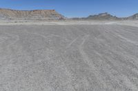 a red truck is driving through the rocky landscape of the desert of an arid area