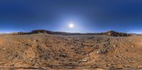 a wide panorama of some rocks on the horizon at night as seen from a fisheye lens