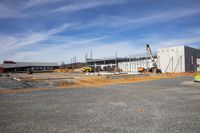 a construction site in an empty lot on a partly sunny day that has been built with concrete blocks