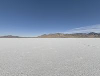 a person is running across the desert area while holding a frisbee in hand