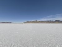 a person is running across the desert area while holding a frisbee in hand