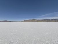 a person is running across the desert area while holding a frisbee in hand