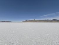 a person is running across the desert area while holding a frisbee in hand