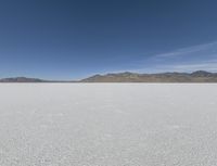 a person is running across the desert area while holding a frisbee in hand