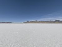 a person is running across the desert area while holding a frisbee in hand