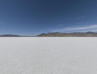 a person is running across the desert area while holding a frisbee in hand