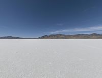 a person is running across the desert area while holding a frisbee in hand