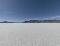 a person is running across the desert area while holding a frisbee in hand