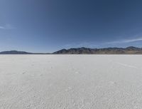 a person is running across the desert area while holding a frisbee in hand