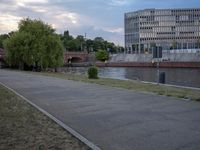 a man is running in the middle of a waterway near a building and a water way