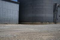 a street view of two round silos outside a storage building with a sign on one side
