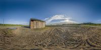 the old, wooden shack is left in an open field by the farmer and his wife