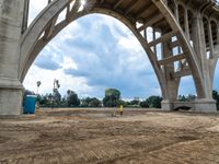 a construction scene of the roadway overpass near an intersection that is under construction, with a sky background