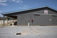 the building has no doors or signs on it as well as the entrance to a toilet