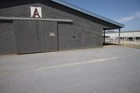 the building has no doors or signs on it as well as the entrance to a toilet