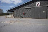 the building has no doors or signs on it as well as the entrance to a toilet