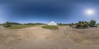 a 360 - vr panorama is showing people on a dirt hill, one on top of the other