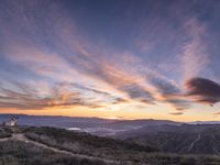 Rural California: An Open Road amidst Grass and Mountains